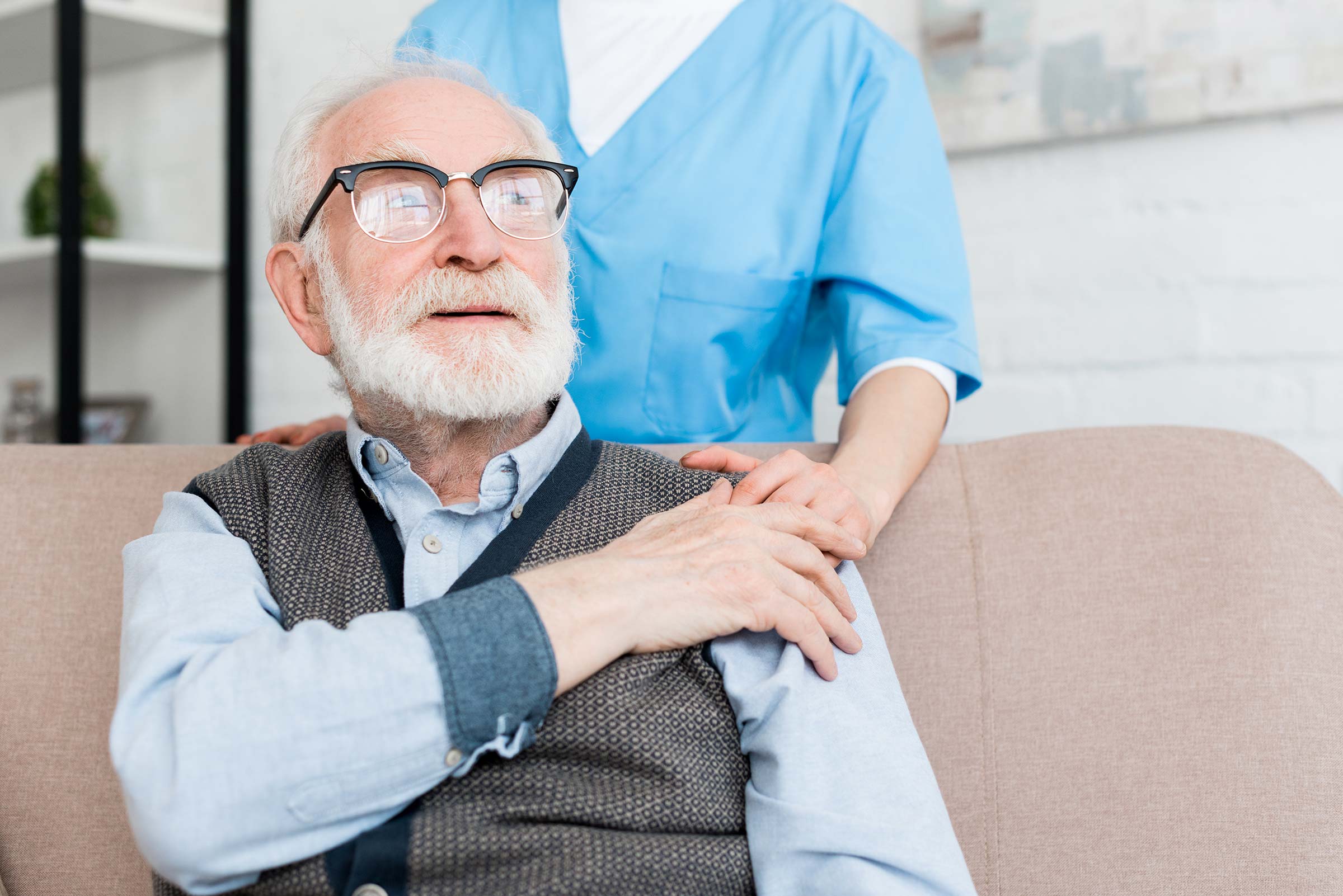 Doctor supporting elderly patient by placing hand on patient's shoulder