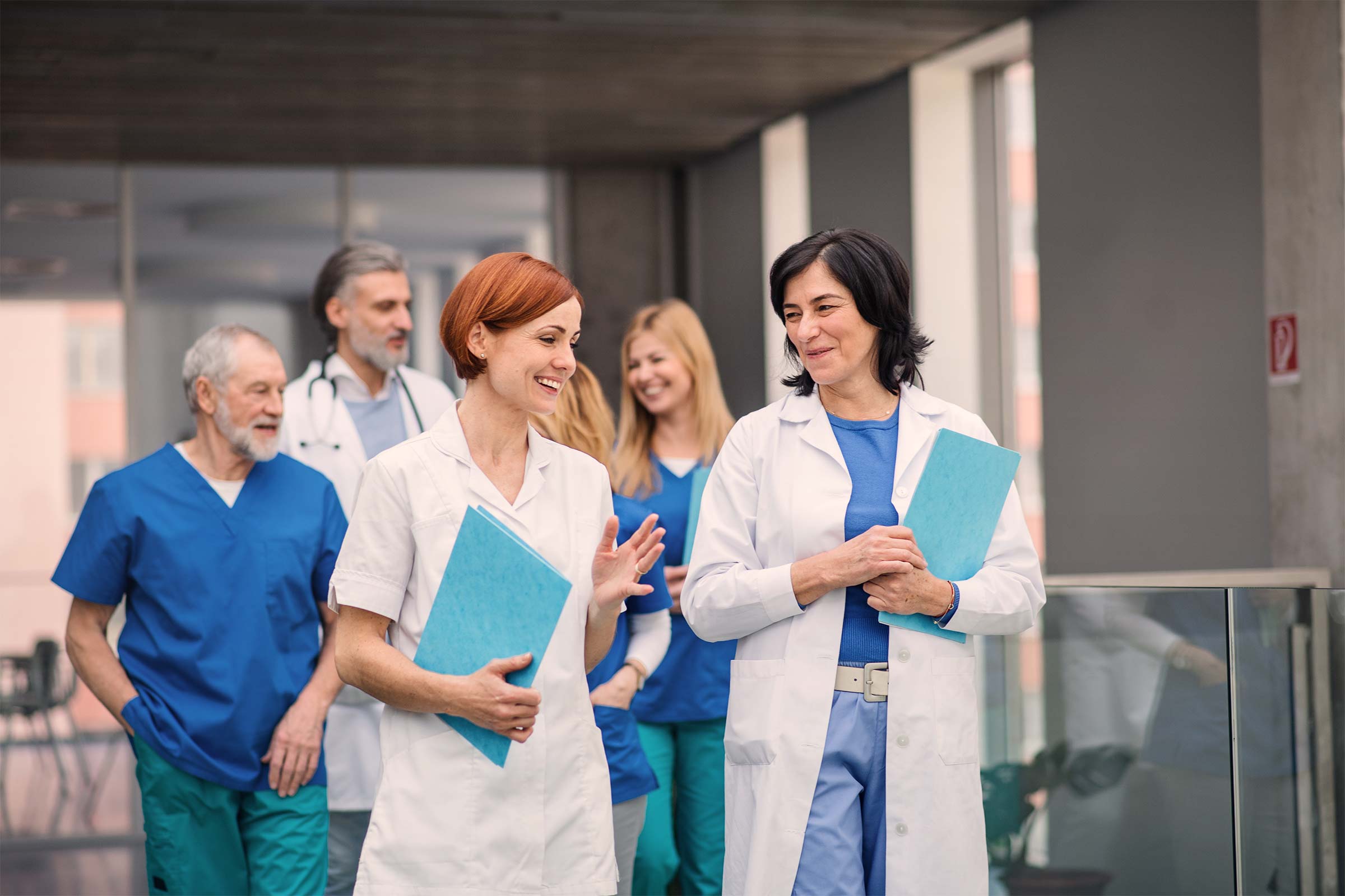 Group of doctors walking and talking in corridor