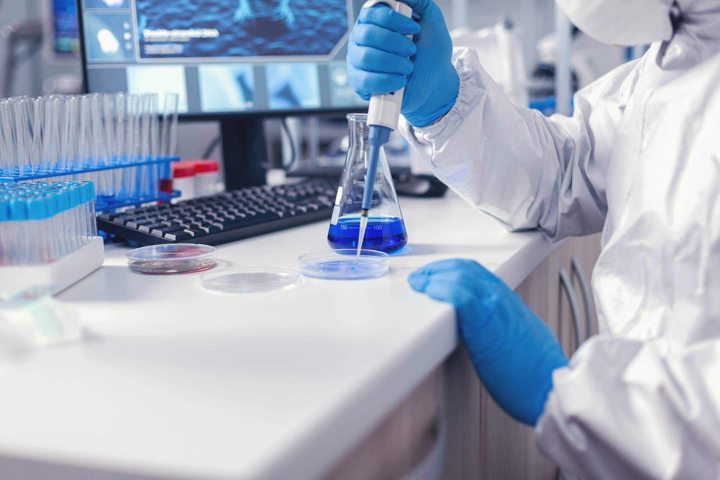 Medicine scientist pouring liquid on petri dish working in lab with micropipette.